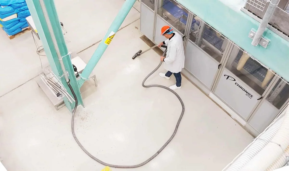 A man using a industrial centeal vacuum cleaner